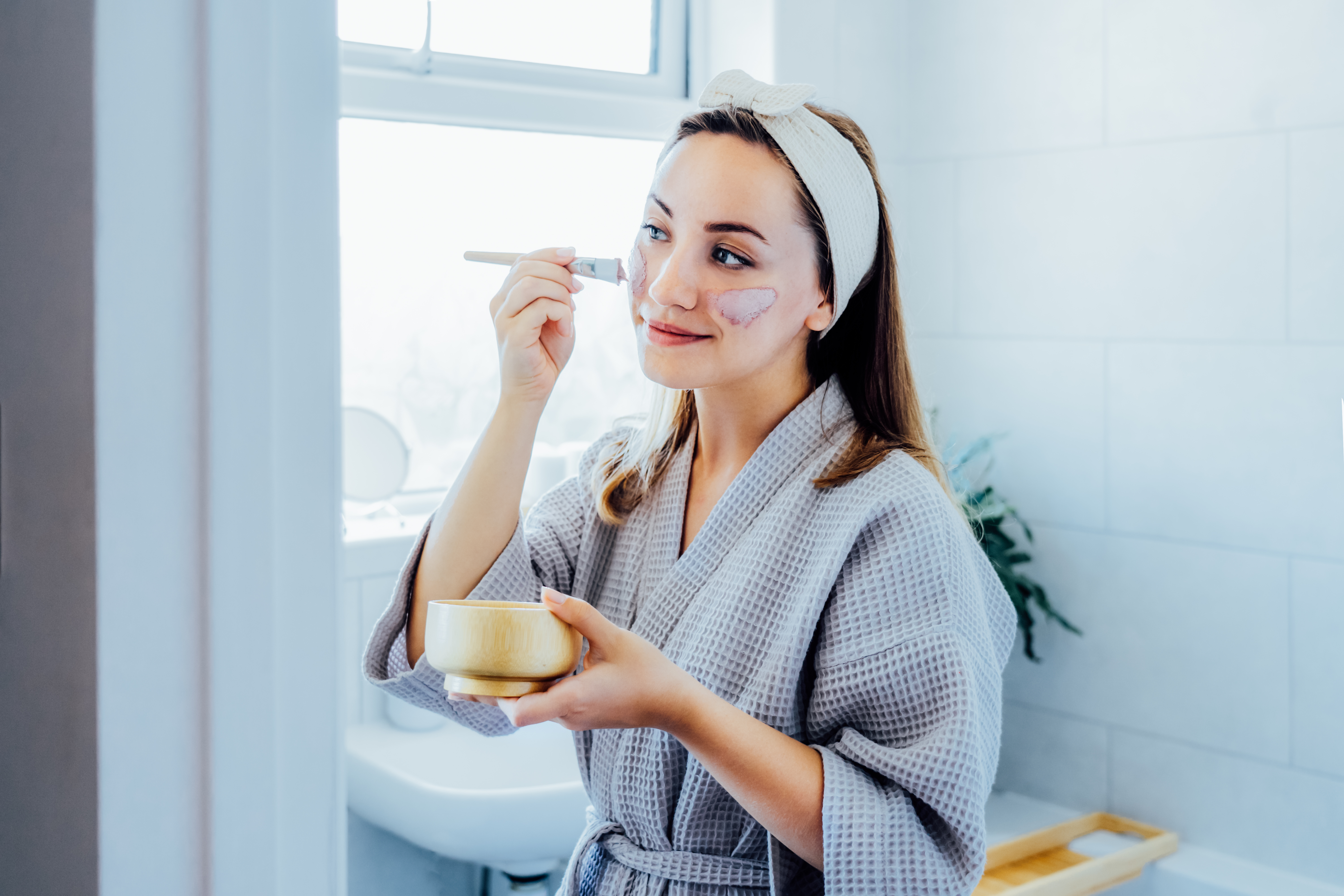 young-woman-in-bathrobe-looking-in-the